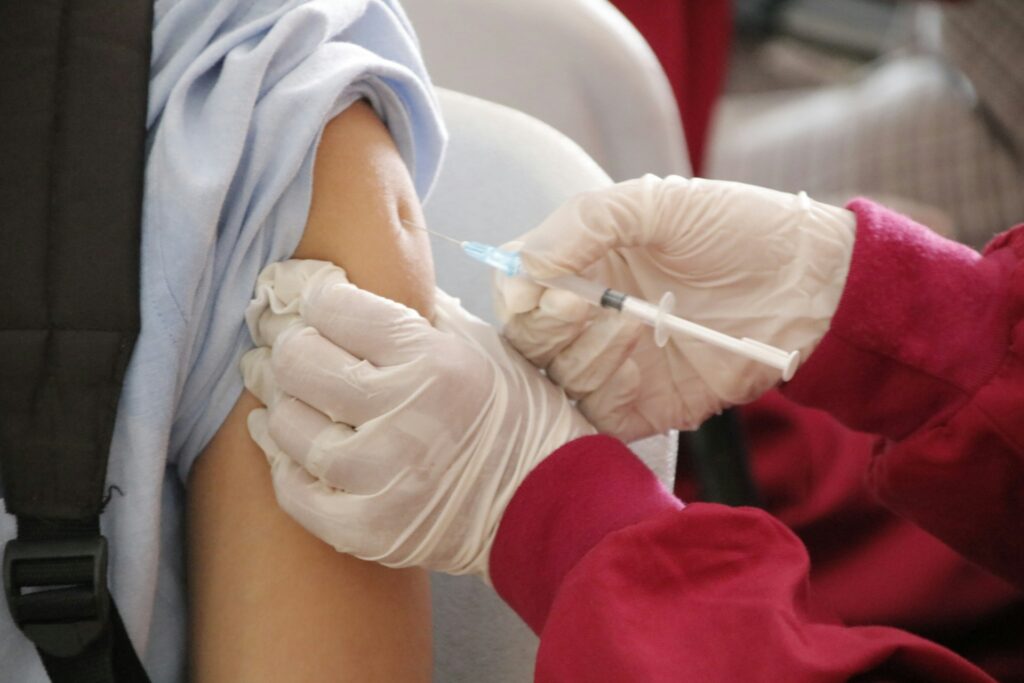 Healthcare professional giving travel vaccines
